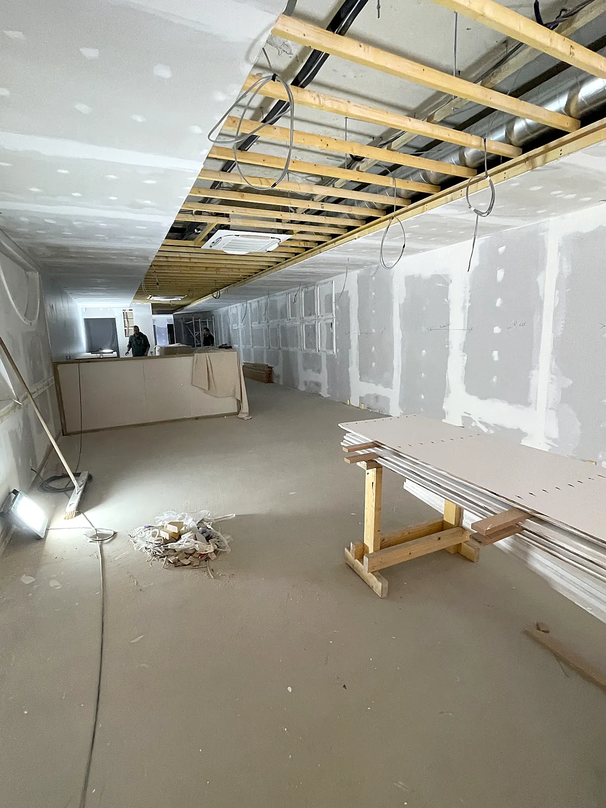 Commercial ceiling first fix with lighting and power cabling run above the grid