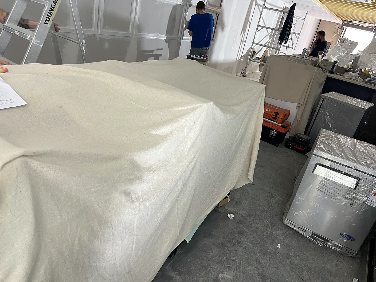 Stainless steel commercial kitchen during fit-out with equipment supplies being installed