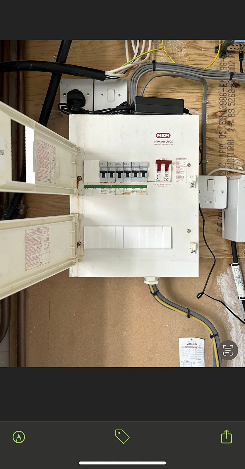 Consumer unit open during installation showing circuit breakers and wiring in Glasgow