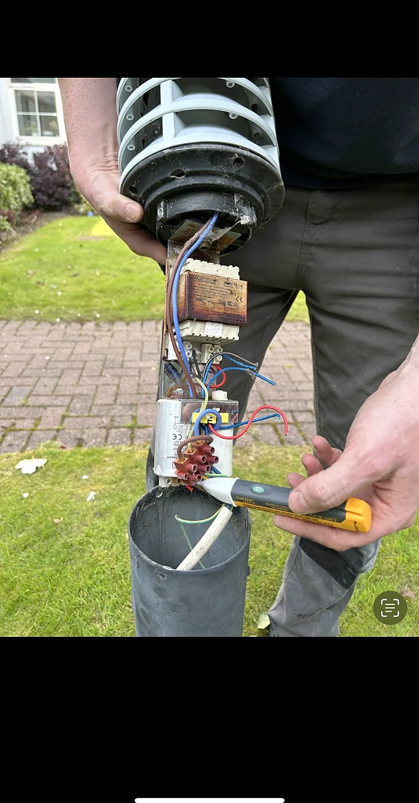 Garden bollard light being wired during an outdoor lighting installation in Glasgow