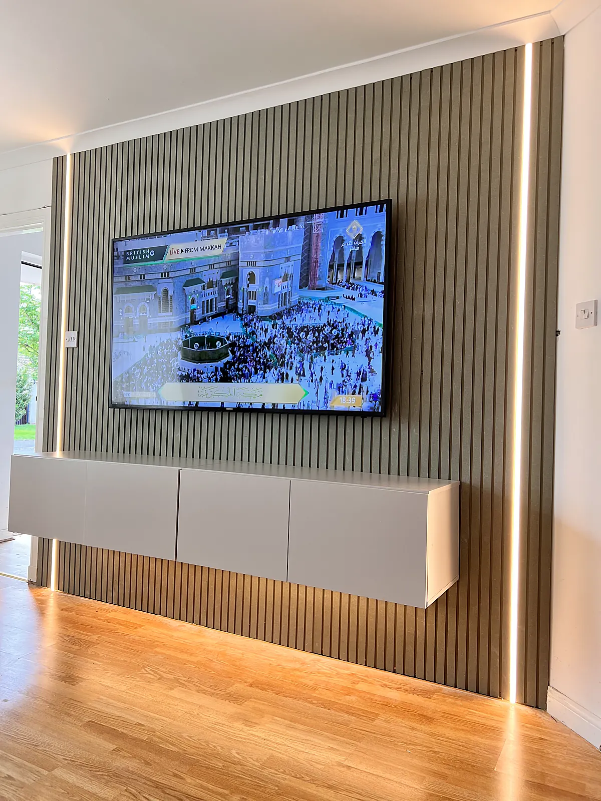 Media wall with floating unit and warm concealed lighting installed by MMM Electrical in Glasgow