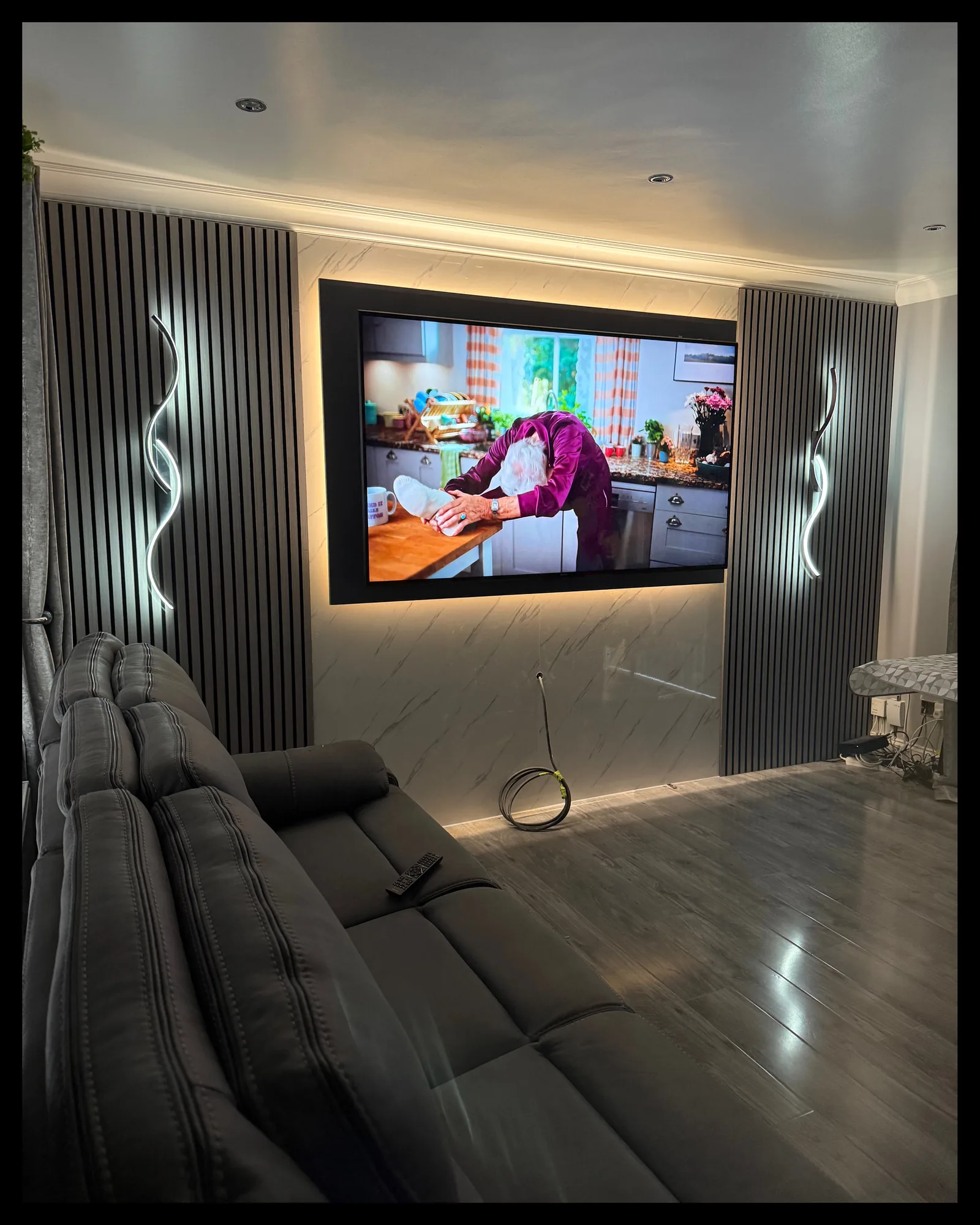 Living room feature wall with a recessed television and concealed LED lighting, electrical installation by MMM Electrical in Glasgow