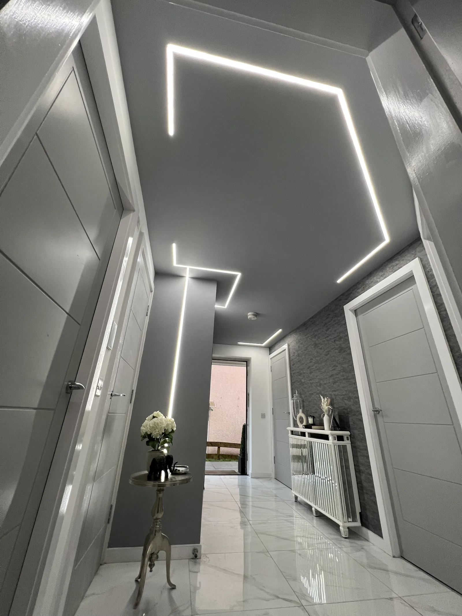 Hallway with recessed linear LED lighting installed by MMM Electrical