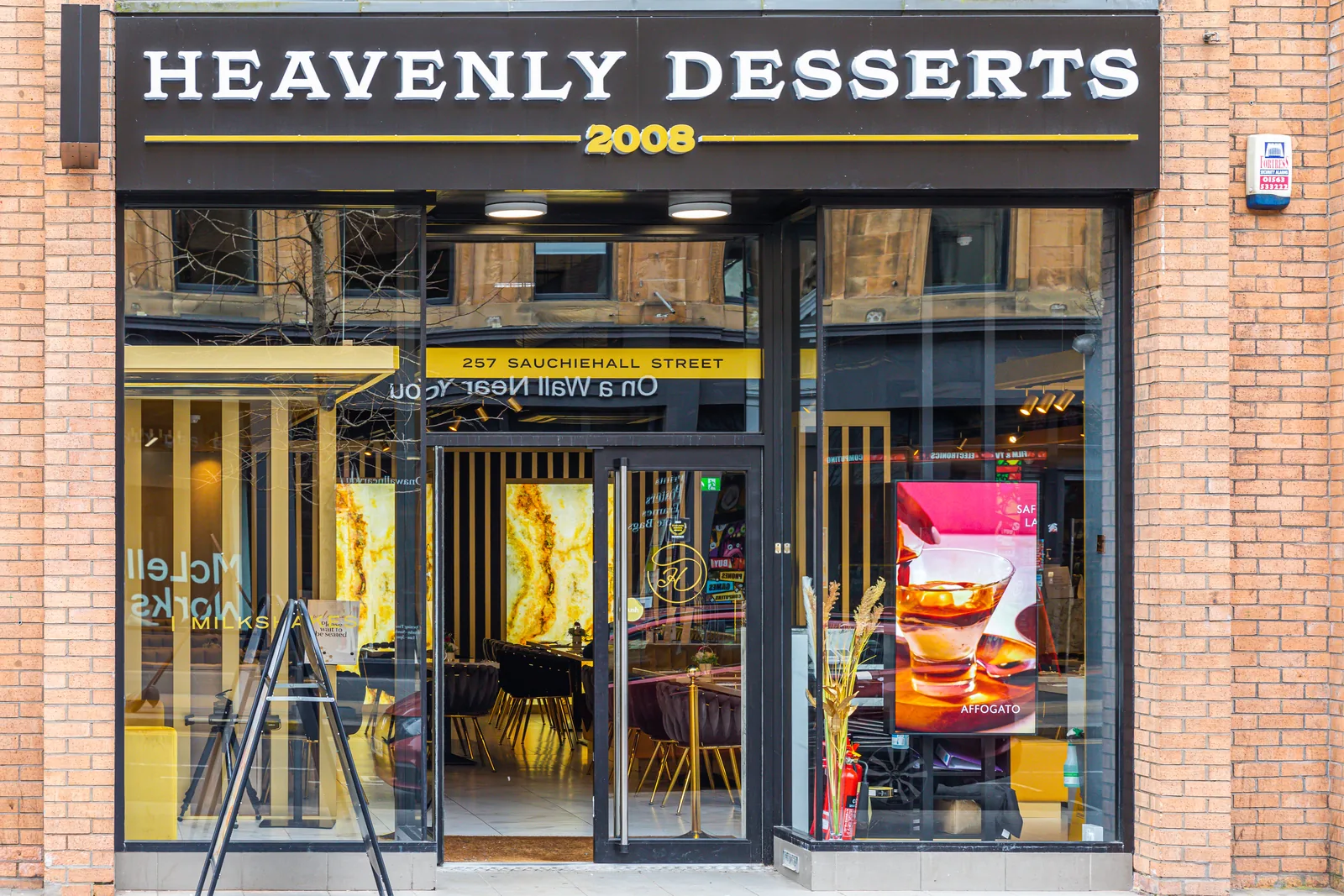 Illuminated shopfront of Heavenly Desserts on Sauchiehall Street, Glasgow, with signage and window lighting supplies installed by MMM Electrical